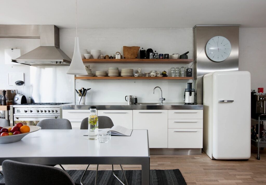Bright modern kitchen with organized work surfaces and warm wood accents
